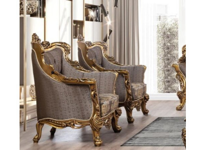 Een luxueuze klassieke fauteuil in donkergrijs met een gouden barokdesign van Chesterfield